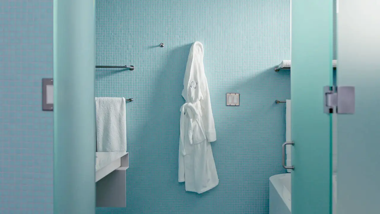 Frame Treehouse spa-like bathroom with a soaking tub, stone surfaces, and natural light