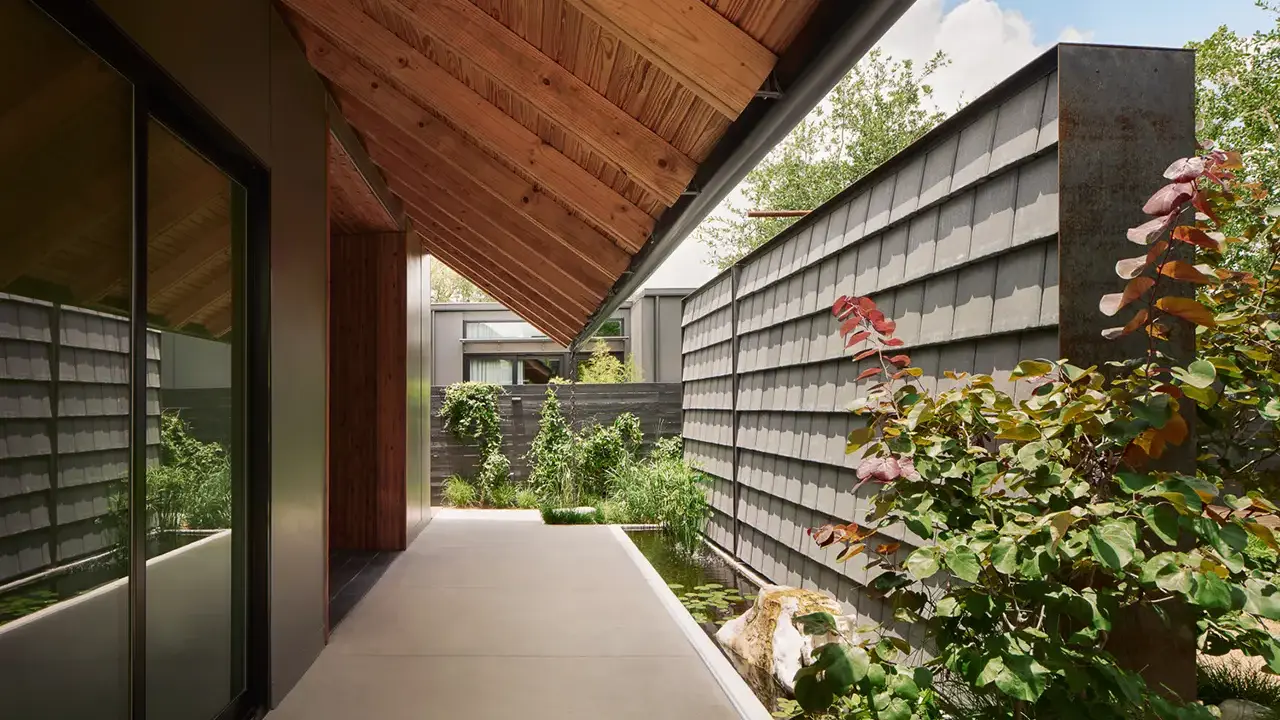 Frame SoCo courtyard with koi pond and quiet lounge seating